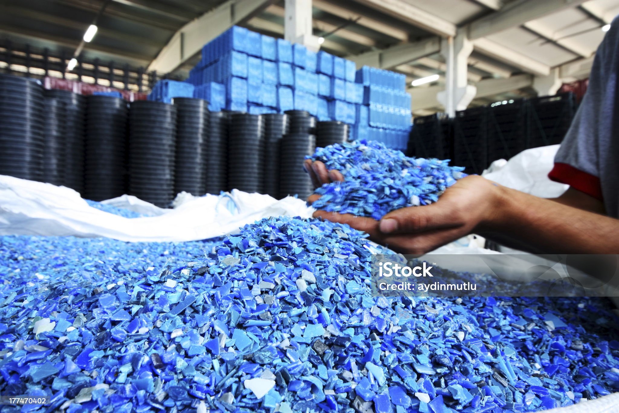 Plastic Resin pellets in holding hands.